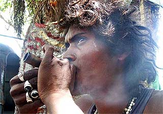 A sadhu smokes 'ganja'