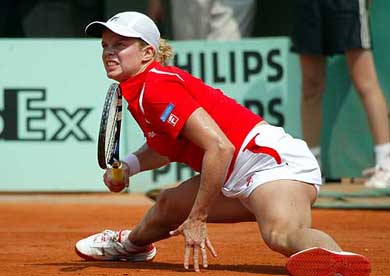 Kim Clijsters of Belgium stretches as she returns the ball to Paola Suarez of Argentina in their round match