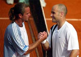 Andre Agassi of the USA  shakes hands with Xavier Malisse of Belgium after their third round match