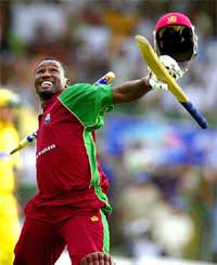 Wavell Hinds of West Indies runs off the field with a stump after hitting the winning boundary