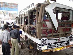 Pakistani officials examine a bus
