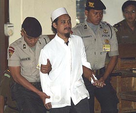 Imam Samudra, the alleged mastermind behind last year's Bali bomb blasts, is escorted into a court