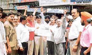 BJP workers stage a demonstration against Mr Surinder Dawer at the Samrala Road