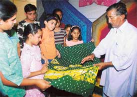 Bashir Khan exhibits tie-and-dye cloth at an exhibition held as part of workshops organised by the Kala Sewa Society 