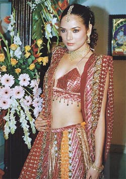A model wearing a richly designed ensemble by Anshu Mod