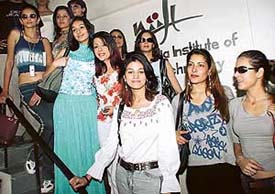 Models, who are all set to participate in a NIIFT design collection show on Thursday, pose for a photograph at a press conference in SAS Nagar on Wednesday.