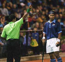 India's Jugraj Sing is sent off by the referee for a rough tackle