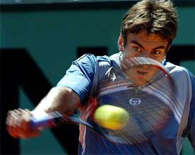 Tommy Robredo of Spain returns to his compatriot Albert Costa