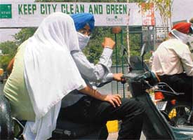 Commuters devise ways to beat the heat in Ludhiana on Friday