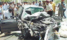 Relatives collect the belongings of the victims from the car wreckage