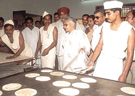 WHAT�S COOKING? Delhi Chief Minister Sheila Dikshit taking a dekko at the  �chapatis� made by the prisoners after the inauguration of Jail No. 7 at Tihar in the Capital on Friday. Photo by Kamal Singh