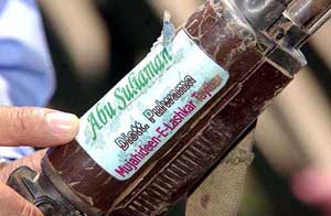 An Army officer points towards the sticker