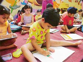 Children take part in a painting contest during a summer workshop at Love Dale Montessori 