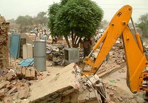 Dwellings and structures being demolished during an anti-encroachment drive