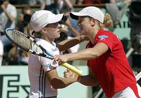 Justine Henin-Hardenne of Belgium is congratulated by compatriot Kim Clijsters