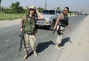 Women soldiers of the International Security Assistance Force stand guard