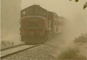 Only the engine of a train is visible due to a thick cloud of dust at Bathinda on Sunday.