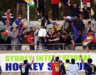 Indian captain Dhanraj Pillay waves the national flag in front of fans 