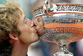 Juan Carlos Ferrero of Spain kisses the trophy after defeating Martin Verkerk of the Netherlands in the final of the French Open
