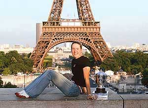 Justine Henin-Hardenne of Belgium poses in front of the Eiffel Tower with her trophy 