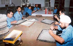 Disabled soldiers learning vocational skills at the paraplegic rehabilitation centre at SAS Nagar