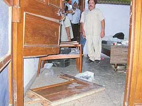 The occupant of a house in Sector 37, Mr Rakesh Khurana, stands near the broken door through which burglars entered his house on Sunday night
