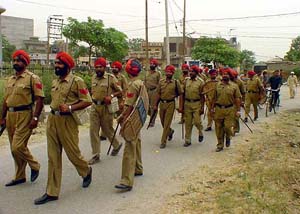 Punjab Police personnel patrol one of the affected residential areas of Phagwara on Monday