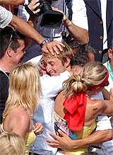 Spain's Juan Carlos Ferrero hugs his relatives after defeating Martin Verkerk of the Netherlands