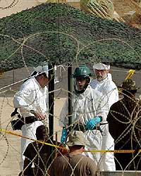 UN nuclear experts speak with US soldiers at the Tuwaitha storage site near Baghdad on Monday