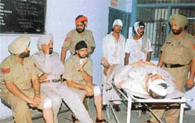 Injured policemen and rickshaw-pullers wait at the Civil Hospital for medical examination