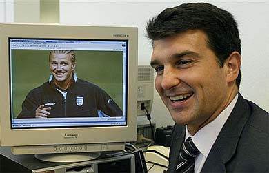 Spanish soccer club Barcelona's presidential hopeful Joan Laporta smiles next to a computer displaying a picture of David Beckham