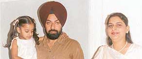 Maninder with his wife and child