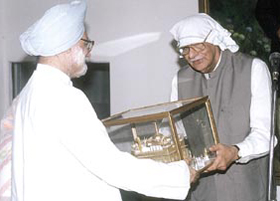 Dr Manmohan Singh  presenting a model of the Golden Temple to Mr Kuldip Nayar at a function at Bhai Vir Singh Sadan in the Capital. 