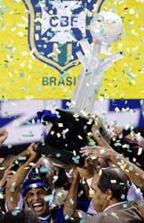 Cruzeiro's captain Alex de Souza raises the Copa do Brazil trophy after defeating Flamengo