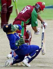 Sri Lanka�s wicketkeeper Romesh Kaluwitharana holds his face