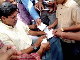 Former Indian skipper Kapil Dev gives autographs