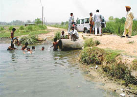 A water pool that emerged due to leakages in the main pipeline of the Kajauli waterworks near Maloya village
