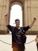 British runner Robert Garside raises his hands, moments after competing a six-year long around the world journey by foot