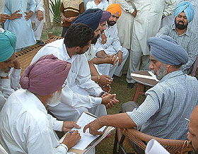 Mr Jaspal Singh, DSP, Vigilance Bureau (right), records a statement in connection with the case against Mr Narottam Singh Dhillon, a cousin of Mr Parkash Singh Badal, former Chief Minister, in Badal village on Friday.