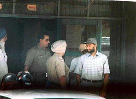 Policeman Paramjit Singh, who is wanted by the Vigilance Bureau, was seen with some police officials