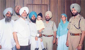 Police officials with five-year-old Gurjit Singh, who was rescued within eight hours