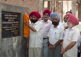 Member of Parliament Bhan Singh Bhaura and Principal P. S. Bhatti lay the foundation stone