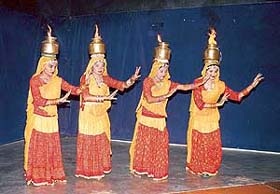 Physically challenged children from Shailaj�s institute "Baisakhi" sport burning vessels as they perform chari --- a Rajasthani folk dance at Pracheen Kala Kendra
