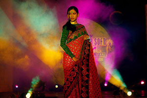 A model poses in a traditional Indian outfit