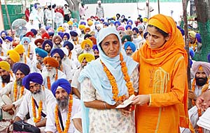 Bibi Kulwant Kaur, widow of a "dharmi fauji", is felicitated at a function in Chandigarh on Sunday