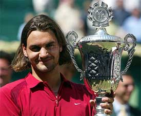 Roger Federer of Switzerland holds the Gerry Weber Open trophy