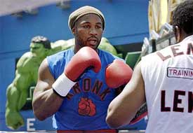 Lennox Lewis, WBC and IBO heavyweight champion, spars with Emanuel Steward during a public workout 