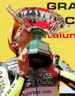 French 250cc rider Randy de Puniet kisses his trophy after winning the race at the Montmelo track