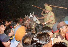 The police uses batons to disperse the crowd that had gone to attend the Gurdas Mann nite at South City