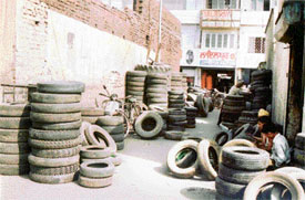 Heaps of tyres stacked all over the road in the tyre market